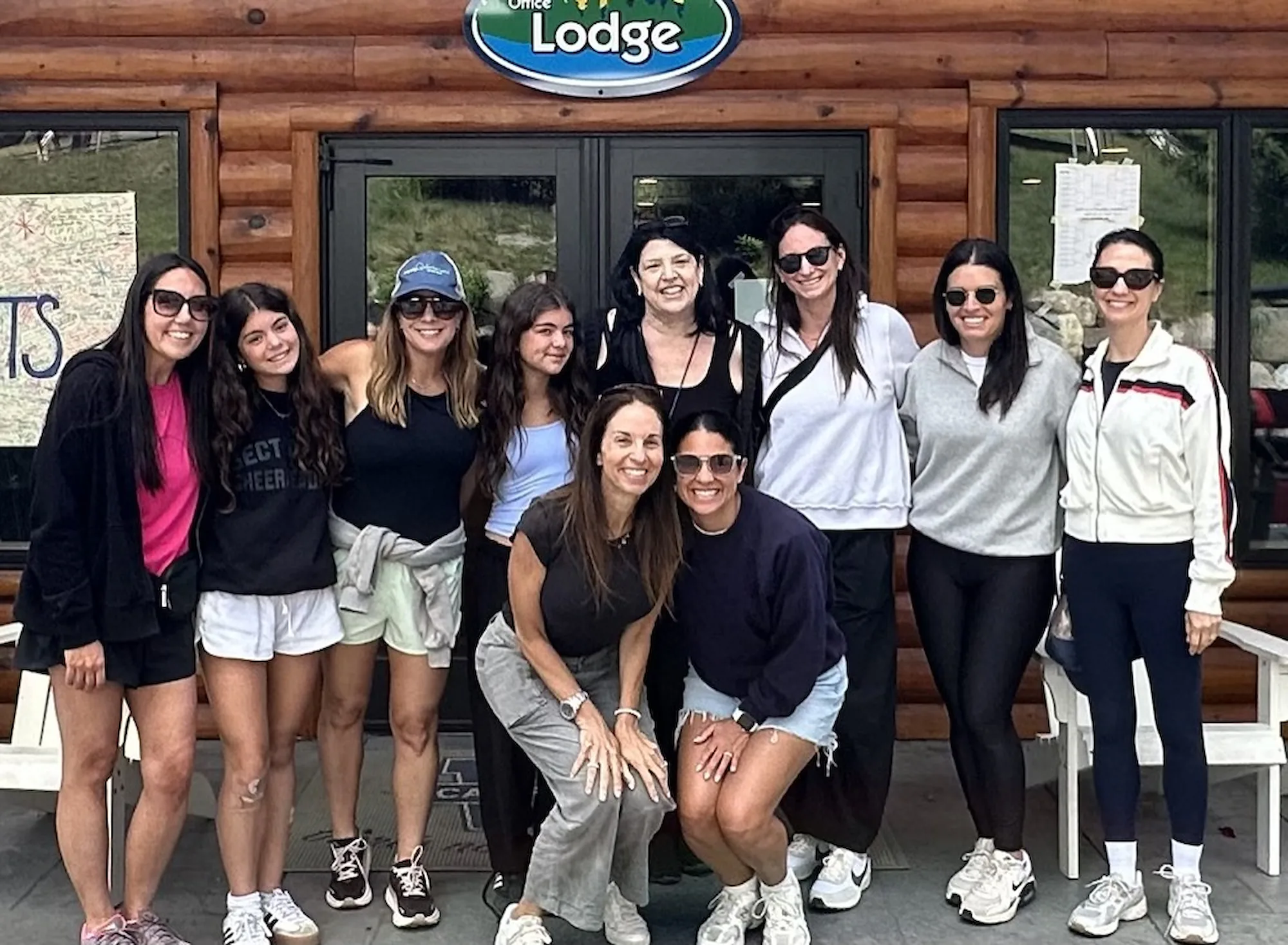 The Camp Specialists team gathered outside a camp lodge