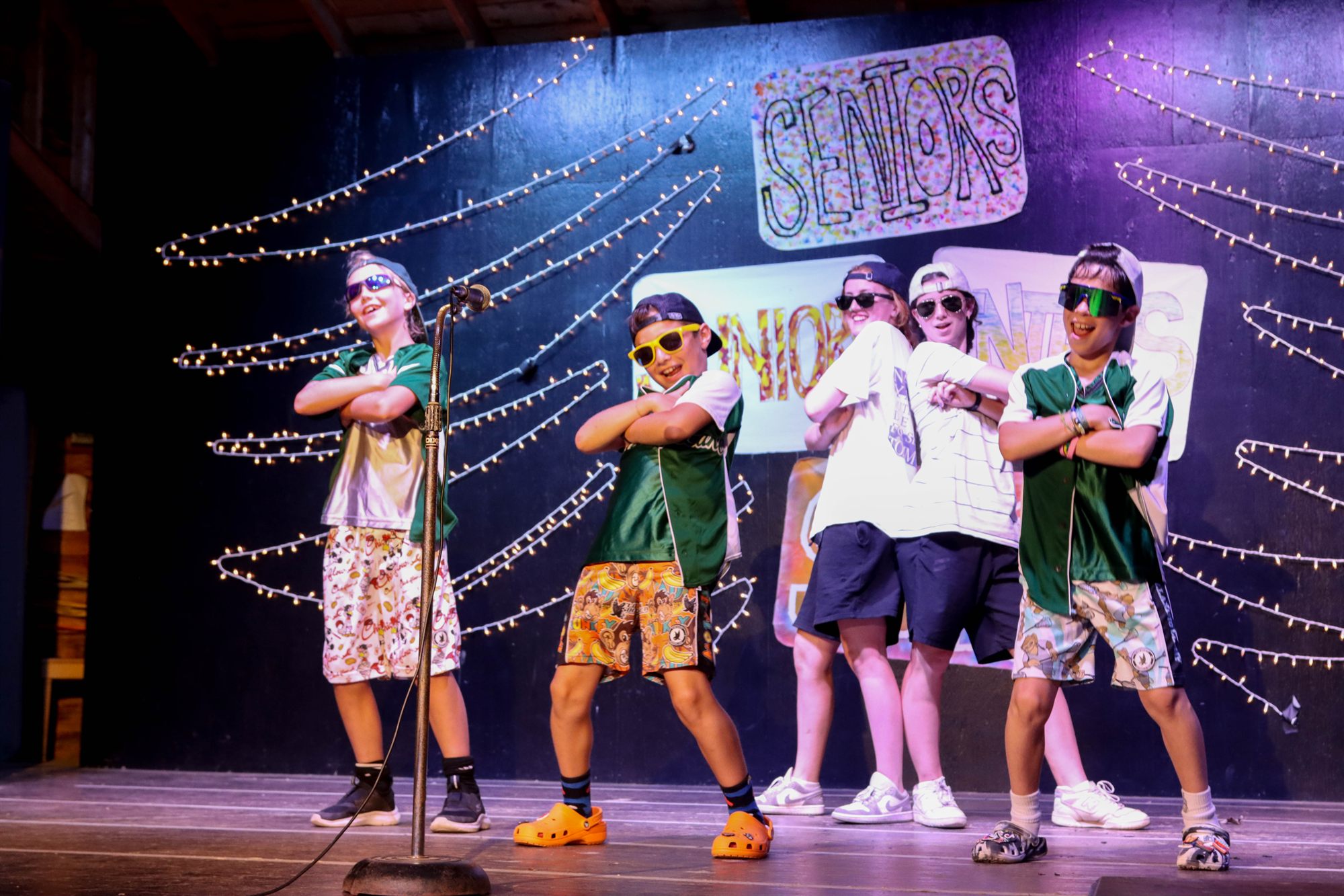 Campers performing on a lit stage at the camp show