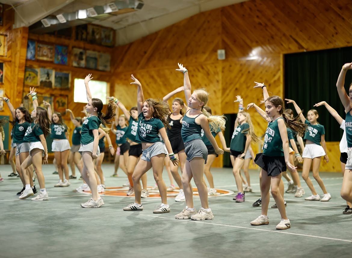 Campers dancing together in the camp field house