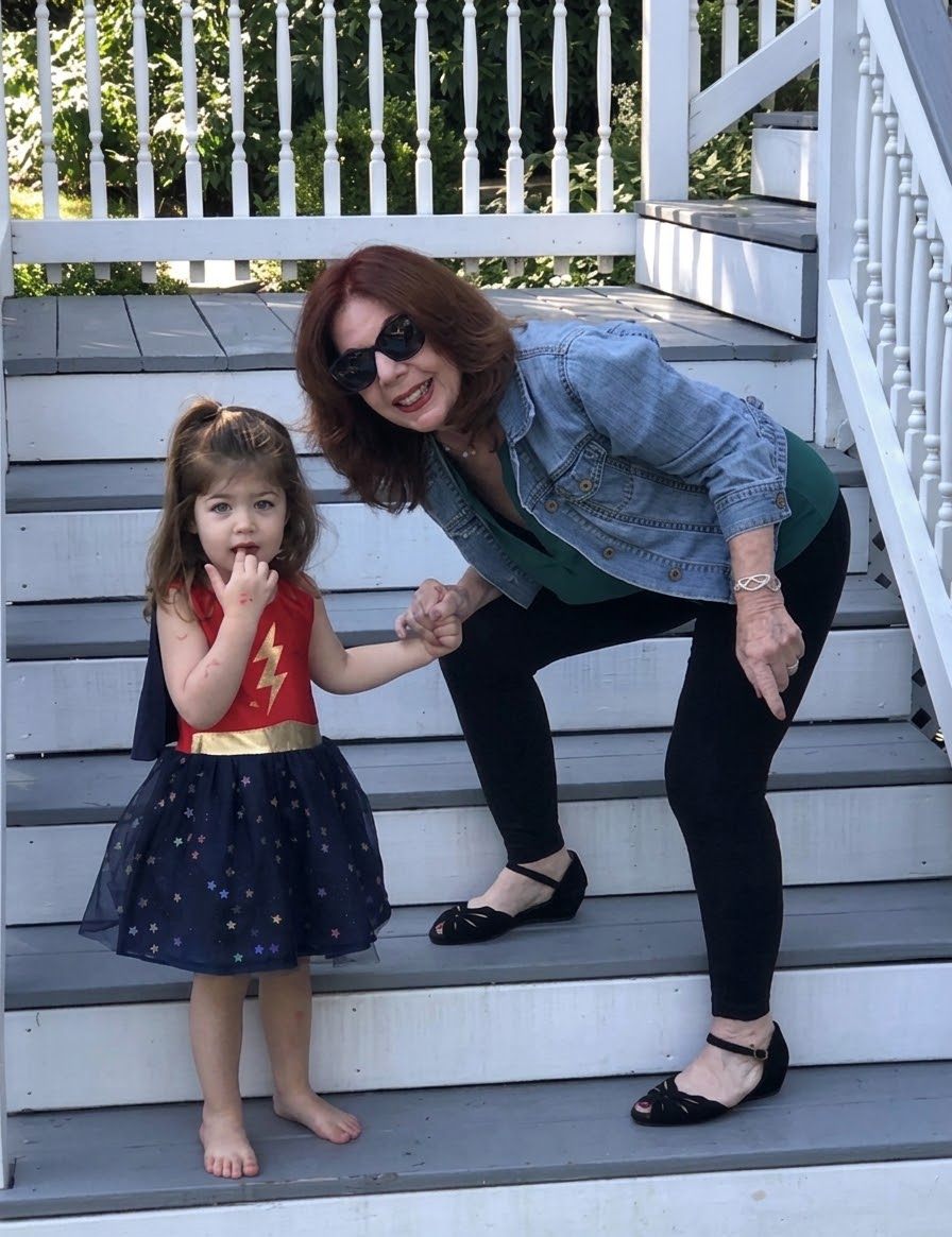 Arlene Streisand on the porch steps with her granddaughter