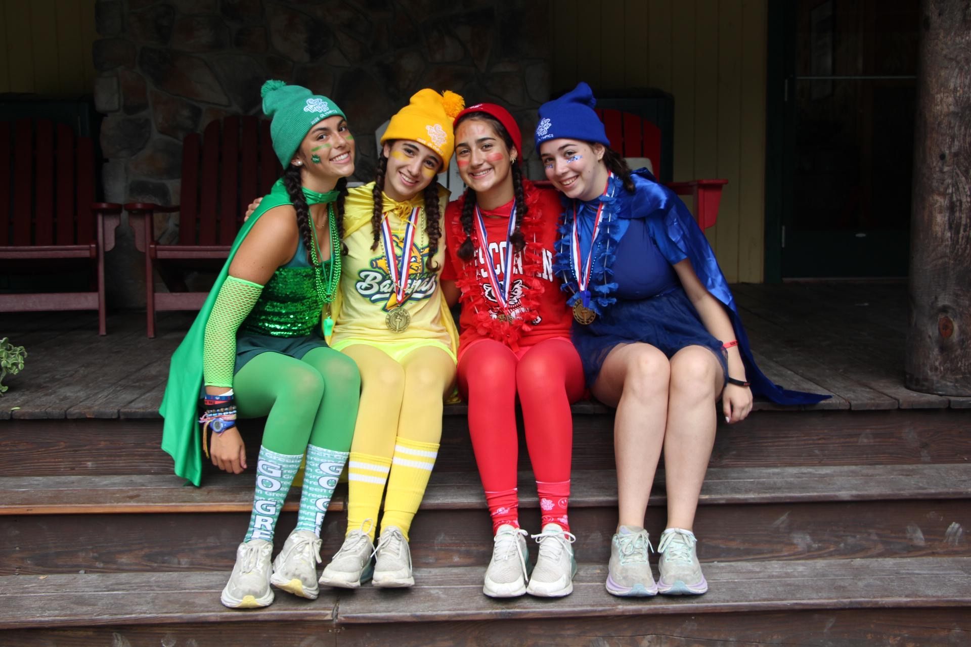 A crew of campers in matching costumes celebrating together